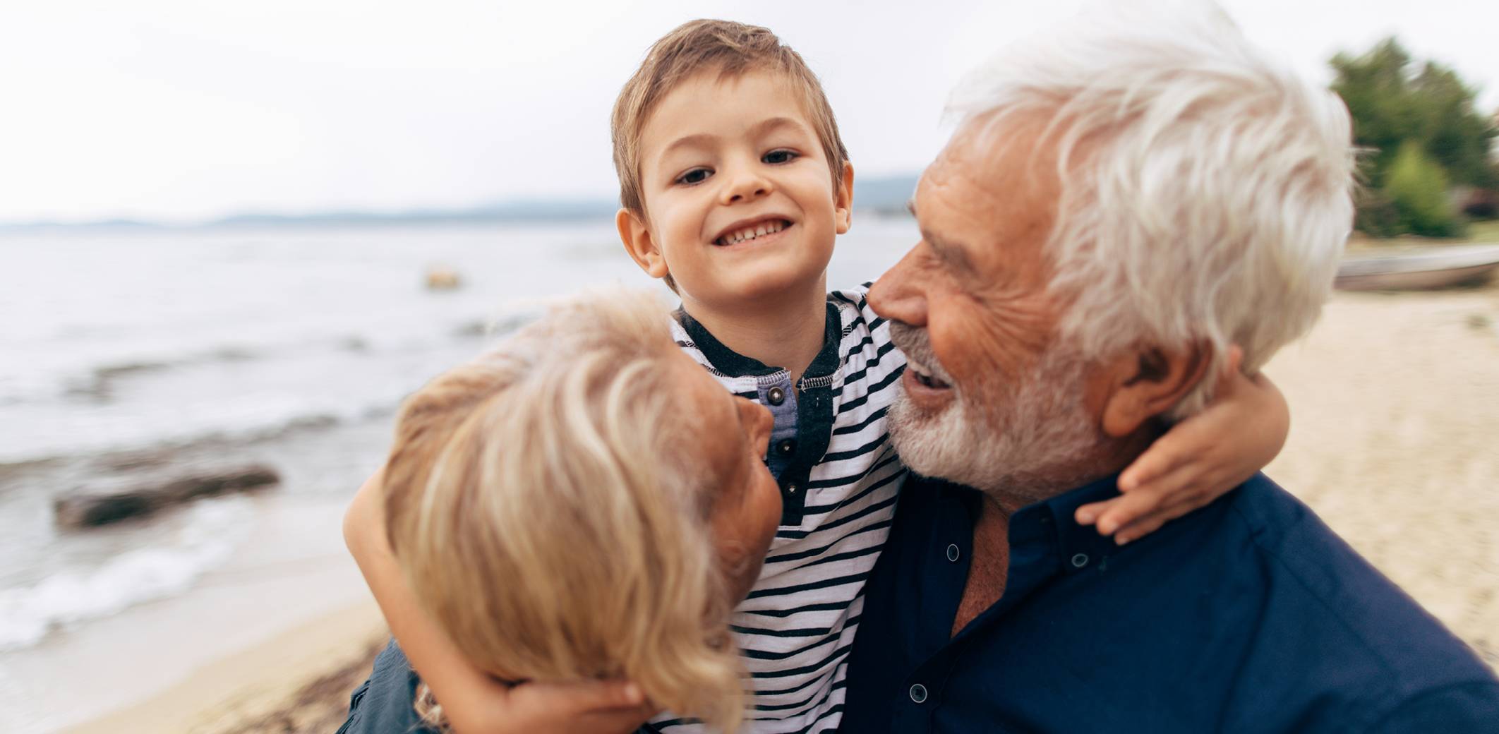 boy-with-grandparents-on-beach